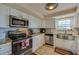 Modern white kitchen with stainless steel appliances and granite countertops at 404 S Beach St # 010 101, Daytona Beach, FL 32114