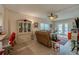 Living room with a ceiling fan, couch, entertainment center, and holiday decor at 404 S Beach St # 010 101, Daytona Beach, FL 32114