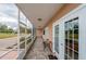 Screened-in patio area with seating and tiled floor at 404 S Beach St # 010 101, Daytona Beach, FL 32114