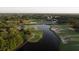 Aerial view of golf course with lake and clubhouse in background at 437 Harbour Town Ln, Ormond Beach, FL 32174