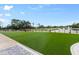 Landscaped backyard with putting green and golf course view at 437 Harbour Town Ln, Ormond Beach, FL 32174