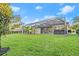 Landscaped backyard with pool and patio at 437 Harbour Town Ln, Ormond Beach, FL 32174