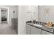 Bathroom with dark vanity and a walk-in shower at 437 Harbour Town Ln, Ormond Beach, FL 32174