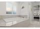 Relaxing bathroom with a freestanding tub and large window at 437 Harbour Town Ln, Ormond Beach, FL 32174