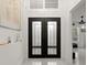 Bright entryway with double doors and modern light fixtures at 437 Harbour Town Ln, Ormond Beach, FL 32174