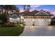 Luxury home exterior featuring a three-car garage and attractive landscaping at 437 Harbour Town Ln, Ormond Beach, FL 32174