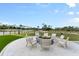Community fire pit with seating overlooking the golf course at 437 Harbour Town Ln, Ormond Beach, FL 32174