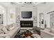 Living room with modern fireplace and large TV at 437 Harbour Town Ln, Ormond Beach, FL 32174