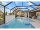 Large screened-in pool with a built-in bar and grilling station at 437 Harbour Town Ln, Ormond Beach, FL 32174
