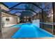 Relaxing pool and spa with a covered lanai and waterfall feature at 437 Harbour Town Ln, Ormond Beach, FL 32174