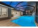 Inviting pool area with a covered lanai, waterfall feature, and outdoor kitchen at 437 Harbour Town Ln, Ormond Beach, FL 32174