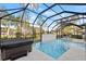 Inviting screened pool and spa with outdoor kitchen at 437 Harbour Town Ln, Ormond Beach, FL 32174