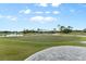 Putting green with view of golf course and lake at 437 Harbour Town Ln, Ormond Beach, FL 32174