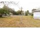 Large backyard with grass and trees at 451 Arthur Ave, Daytona Beach, FL 32114