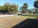 Backyard with grassy area and trees at 451 Arthur Ave, Daytona Beach, FL 32114