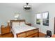 Main bedroom with water views, hardwood floors, and a rustic bed frame at 5178 Riverside Dr, Port Orange, FL 32127