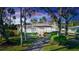 Charming bungalow with lush landscaping, a spacious yard, and a long driveway at 5178 Riverside Dr, Port Orange, FL 32127