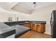 Dark granite countertop wet bar with wood cabinets in basement at 973 Bearded Oaks Ter, Longwood, FL 32779