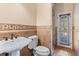Bathroom with pedestal sink, toilet and exterior access at 973 Bearded Oaks Ter, Longwood, FL 32779