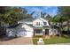 Two-story house with a three-car garage, stone accents, and a manicured lawn at 973 Bearded Oaks Ter, Longwood, FL 32779