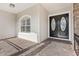 Front entrance with double doors and a side window, showing the stonework at 973 Bearded Oaks Ter, Longwood, FL 32779