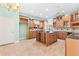 Large kitchen with island, granite counters, and wood cabinets at 973 Bearded Oaks Ter, Longwood, FL 32779