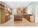 Kitchen boasts an island, granite countertops, and ample cabinetry at 973 Bearded Oaks Ter, Longwood, FL 32779