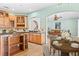 Kitchen features an island, granite countertops, and a dining area at 973 Bearded Oaks Ter, Longwood, FL 32779