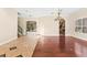Open living area with hardwood and tile floors, chandelier, and access to kitchen at 973 Bearded Oaks Ter, Longwood, FL 32779