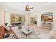 Living room with staged furniture and view of the pool area at 973 Bearded Oaks Ter, Longwood, FL 32779