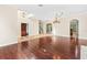 Open living area with hardwood floors, tile entry, and views to kitchen and stairs at 973 Bearded Oaks Ter, Longwood, FL 32779