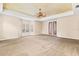 Main bedroom with carpeted floors, tray ceiling, and access to private balcony at 973 Bearded Oaks Ter, Longwood, FL 32779