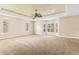 Large main bedroom with carpeted floors and tray ceiling at 973 Bearded Oaks Ter, Longwood, FL 32779