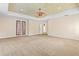 Main bedroom with carpeted floors, tray ceiling, and access to exterior at 973 Bearded Oaks Ter, Longwood, FL 32779