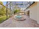 Enclosed pool and spa with brick patio and lush landscaping at 973 Bearded Oaks Ter, Longwood, FL 32779