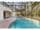 Large freeform pool and spa with screened enclosure at 973 Bearded Oaks Ter, Longwood, FL 32779