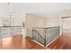 Spacious upper hall with hardwood floors and wrought iron railing at 973 Bearded Oaks Ter, Longwood, FL 32779
