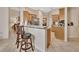 Kitchen boasts a breakfast bar with two stools and views into the living room at 151 Saddlebrook Way, Deland, FL 32724