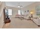 Spacious living room with neutral carpeting and a ceiling fan at 151 Saddlebrook Way, Deland, FL 32724