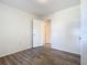 Simple bedroom with wood-look floors and access to hallway at 2129 Lime Tree Dr, Edgewater, FL 32141