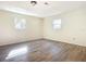 Spacious bedroom featuring wood-look floors and two windows at 2129 Lime Tree Dr, Edgewater, FL 32141