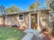 Tan brick ranch home with a brown door and landscaped yard at 2129 Lime Tree Dr, Edgewater, FL 32141
