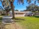 Ranch home with attached garage and spacious grassy yard at 2129 Lime Tree Dr, Edgewater, FL 32141