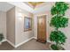 Bright condo entryway with wood door and plants at 2300 N Atlantic Ave # 1701, Daytona Beach, FL 32118