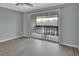 Bright bedroom with wood-look floors and balcony access at 2329 River Ridge Rd # 13, Deland, FL 32720