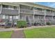 Gray building with multiple units, balconies, and green lawn at 2329 River Ridge Rd # 13, Deland, FL 32720