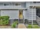Gray siding townhouse with yellow door, steps, and landscaping at 2329 River Ridge Rd # 13, Deland, FL 32720