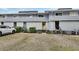 Gray condo building with parking lot at 2329 River Ridge Rd # 13, Deland, FL 32720