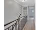 Upstairs hallway with built-in shelving and a staircase at 2329 River Ridge Rd # 13, Deland, FL 32720