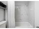 Clean bathroom with marble tile shower/tub combo at 2700 Ocean Shore Blvd # 317, Ormond Beach, FL 32176